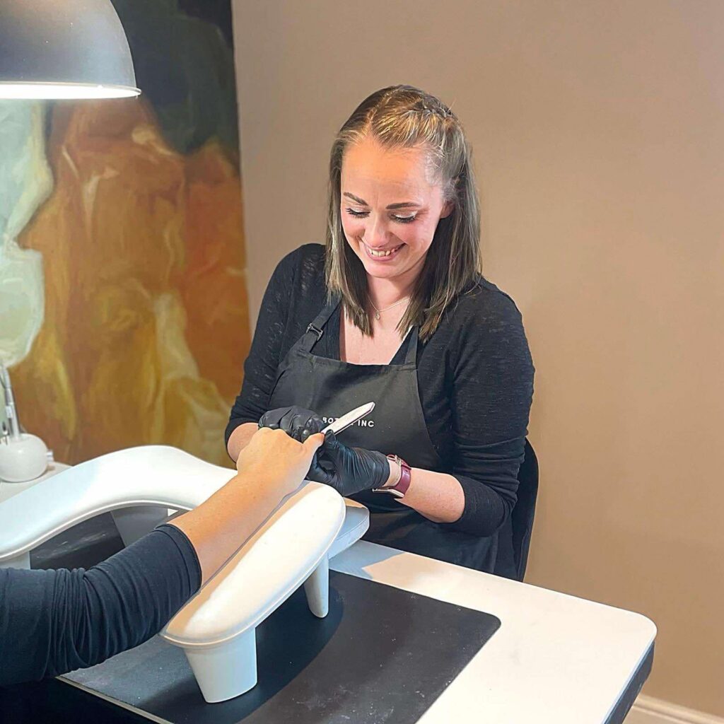 A women doing a mancuire on a customer